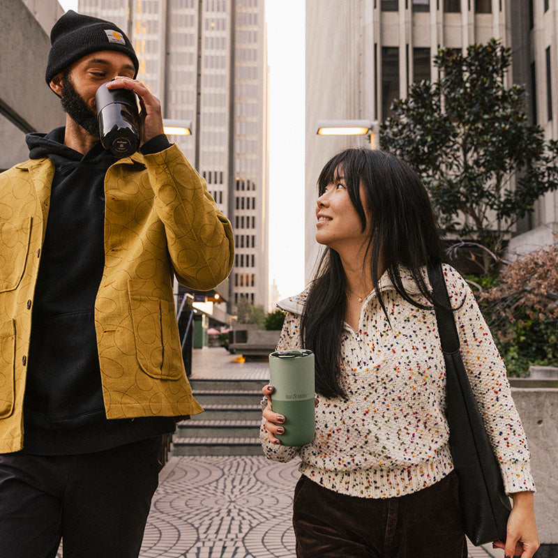 16oz-rise-tumbler-m0 16oz_rise_tumbler_black_iceberg_couple_drink_city_street_square.jpg