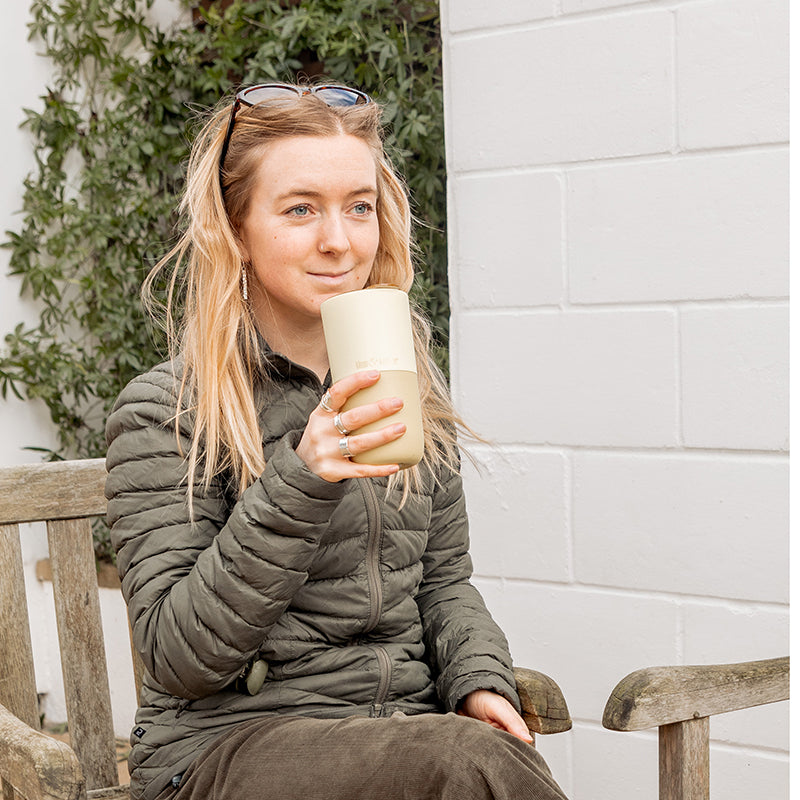 16oz-rise-tumbler-m0 16oz_rise_tumbler_wax_yellow_woman_seat_outside_square.jpg