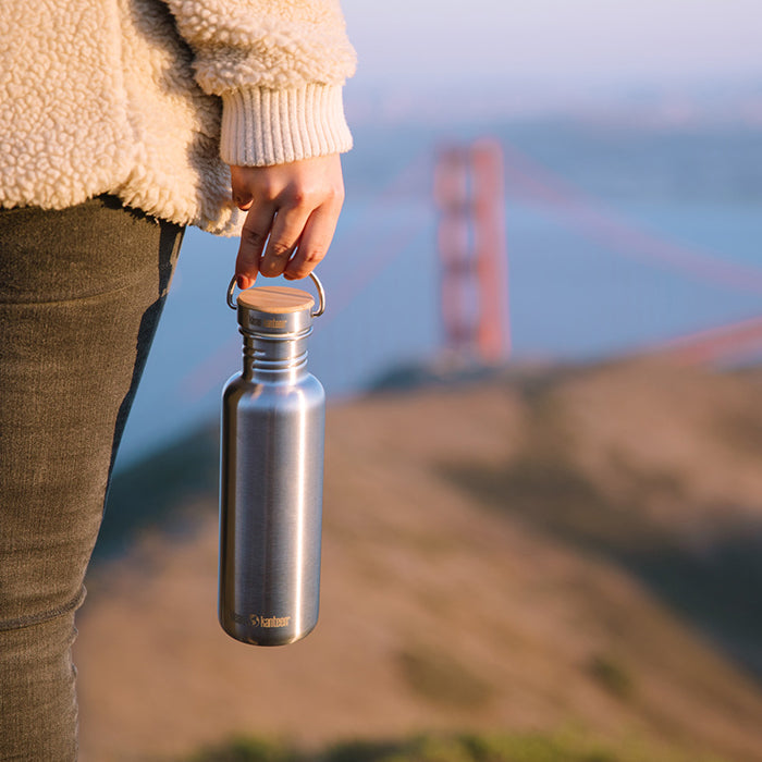 27oz-reflect-with-bamboo-cap-b1 K27SSLRF-BS-BAMBOO_reflect_bottle_bridge_lifestyle.jpg