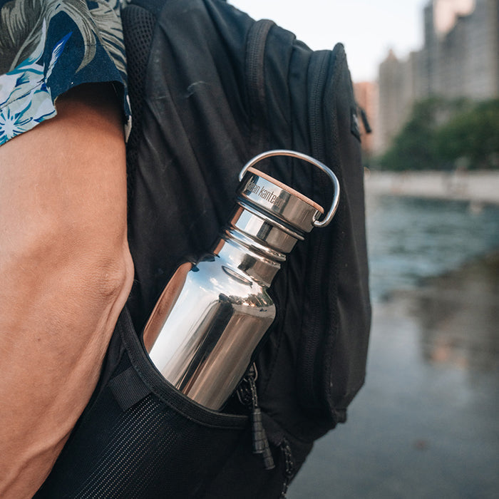 27oz-reflect-with-bamboo-cap-b1 K27SSLRF-MS-BAMBOO_reflect-bottle_backpack_lifestyle.jpg